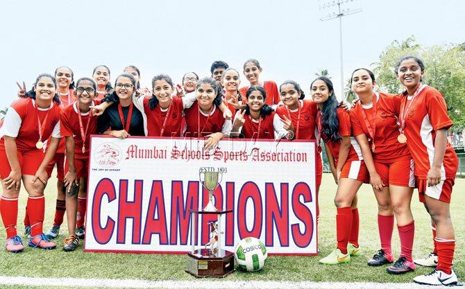 The victorious Arya Vidya Mandir side pose with the trophy after beating Bombay Scottish in the MSSA Div I girls U-16 football final at Cooperage on Saturday. Pics/Shadab Khan
