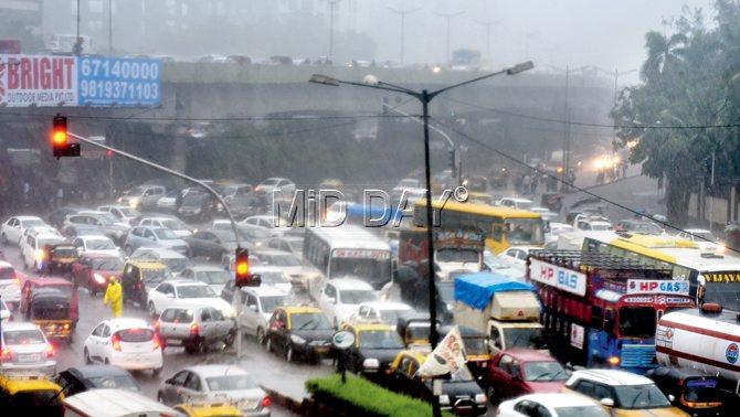 Traffic on WEH in Bandra and residents in Santacruz battle the torrential rain on Tuesday. Pics/Nimesh Dave, Satej Shinde