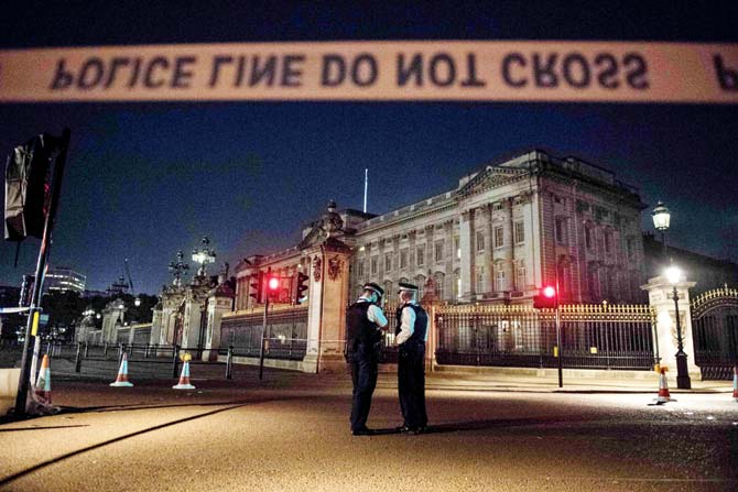 Police officers stand guard at a police cordon next to Buckingham Palace following the knife attack. Pic/AFP