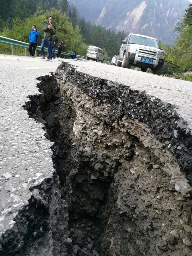 A crack, caused by an earthquake, is seen on a road in Jiuzhaigou in China