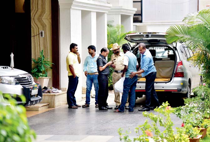 Police and CRPF frisk people during I-T raids at the residence of  D K Shivakumar in Bengaluru. Pic/PTI