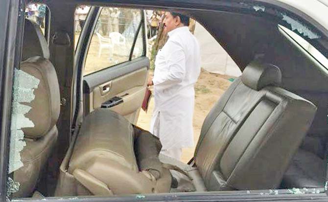 A picture of his damaged car tweeted by Congress. Pics/PTI