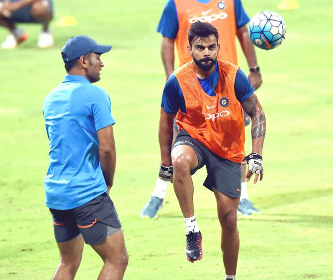  Skipper Virat Kohli and MS Dhoni play soccer during a practice session in Kandy, Sri Lanka on Wednesday. Pic/PTI