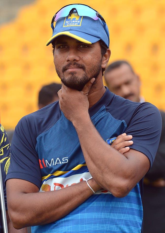 Sri Lankan cricket captain Dinesh Chandimal reacts after the presentation ceremony after India