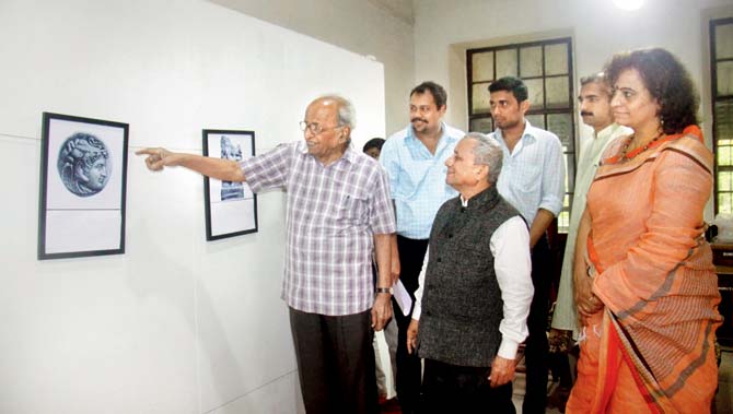 Archaeologist-historian Dr Mukud Keshav Dhavalikar describing various representations of Ganesha across Asia at the exhibition at the Bhandarkar Oriental Research Institute. He is seen with Dr Shrikant Bahulkar, honorary secretary of the institute, who put the archaeologist’s central idea in the form of exhibits. Pics/Mandar Tannu