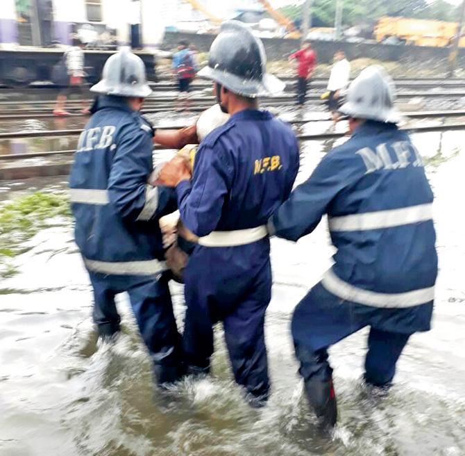 Fire officials rescue the handicapped passengers near Chunabhatti last morning