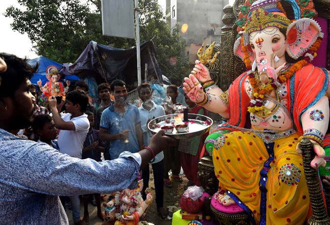 Indian Hindu devotees offer prayer prior to transporting the idol of the Hindu deity Ganesha to their home in New Delhi. Pic/AFP