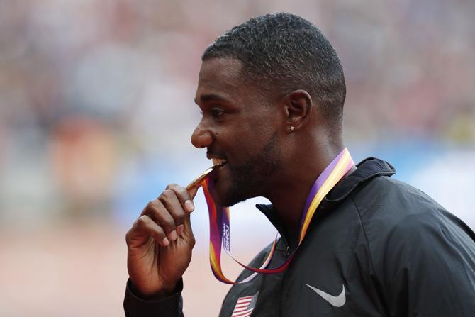 Gold medallist US athlete Justin Gatlin poses on the podium during the victory ceremony for the men