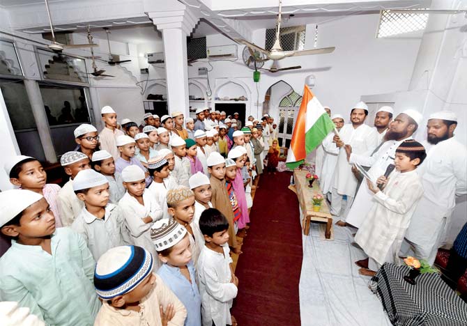 Students at a madrassa prepare for I-Day celebrations in Lucknow. Pic/PTI