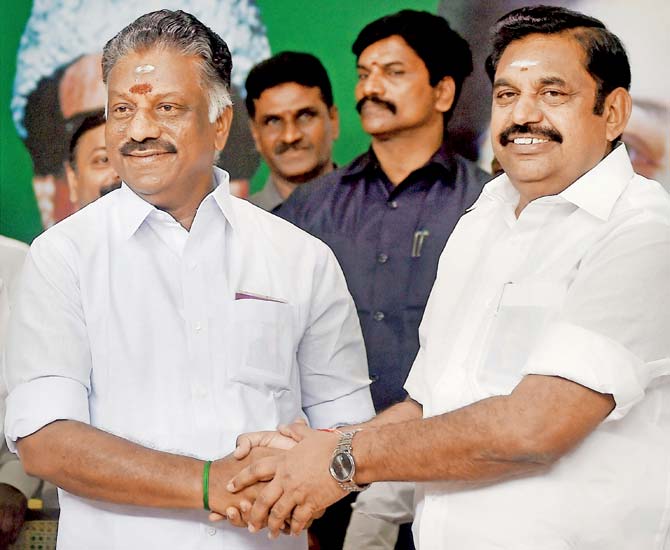 Tamil Nadu Chief Minister K Palaniswami (R) and O Panneerselvam exchange greetings following merger of their factions
