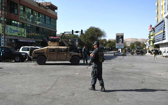 Afghan security personnel stand guard near the site of suicide attack that targeted a Shiite mosque in Kabul. Pic/AFP