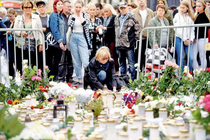 Hundreds gathered to mourn the Turku attack. Pics/AFP