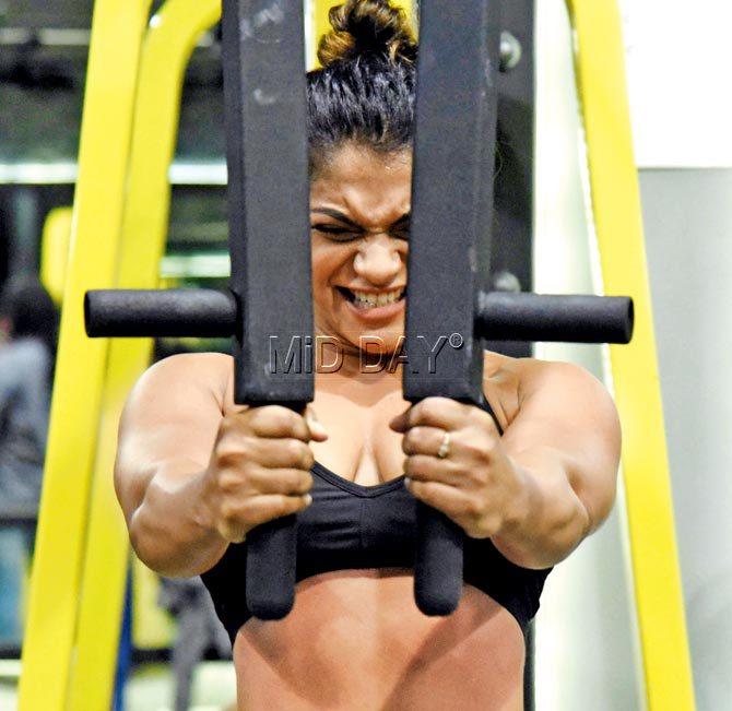 Kuhu Bhosale, a 20-year-old participant at the bodybuilding championship, working out at an Andheri gym. Pics/Rane Ashish