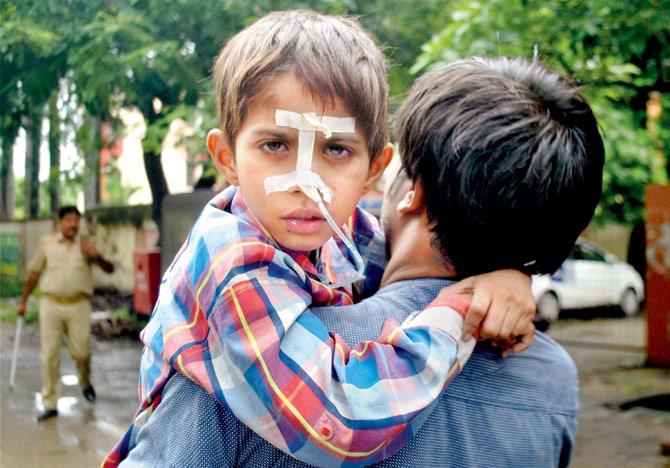 A child is shifted to another ward at Baba Raghav Das Medical College Hospital in Gorakhpur. Pic/PTI