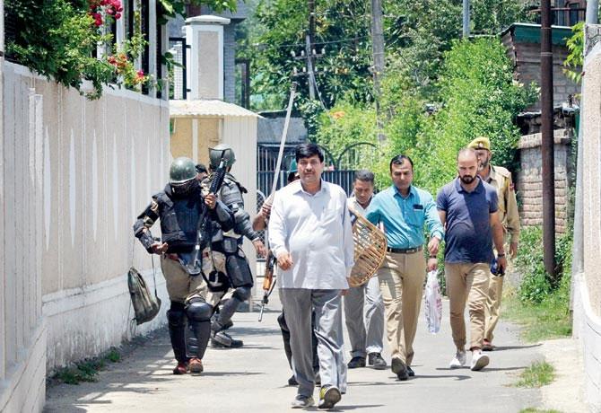 File picture of NIA officials leaving after a raid.