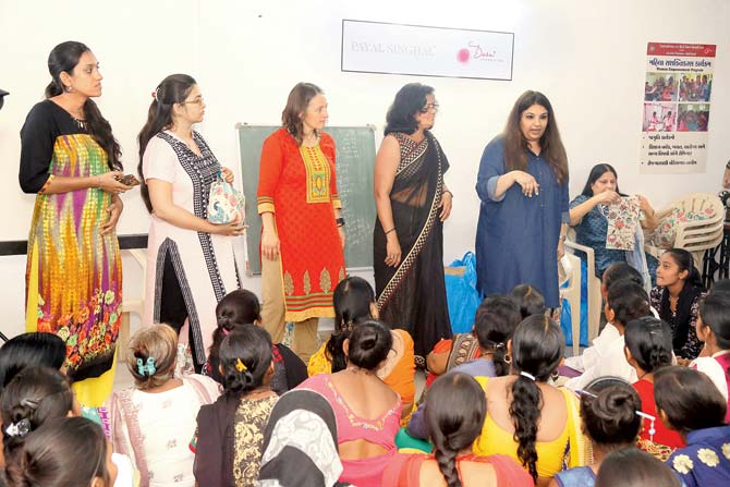 Designer Payal Singhal (standing, in blue) training the women at the sewing centre in Undti, Gujarat