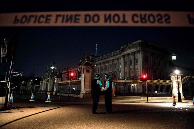 Police officers stand guard at a police cordon next to Buckingham Palace following an incident where a man armed with a knife was arrested outside the palace following a disturbance in London. Pic/AFP
