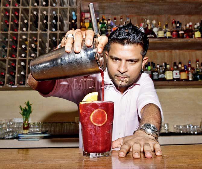Pranav Mody, mixologist at Sassy Spoon, puts final touches on the Berry Berry Khatta