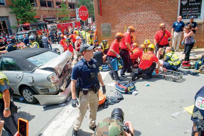 A woman receives first aid after a man drove his car into a crowd of protesters in Charlottesville, VA. Pics/AFP