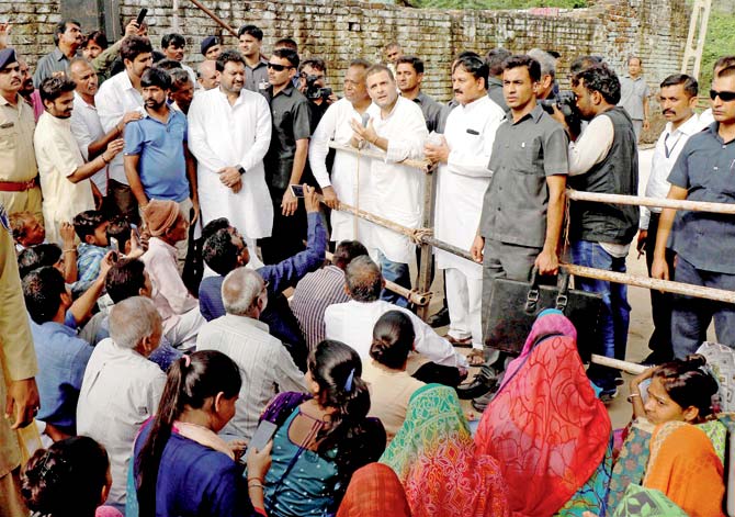 Congress Vice President Rahul Gandhi interacts with the flood affected people of Runi village in Banaskantha