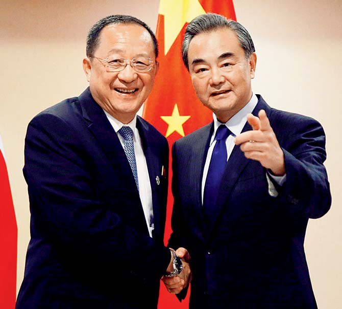 North Korean Foreign Minister Ri Yong Ho (left) is greeted by his Chinese counterpart Wang Yi prior to their bilateral meeting. Pic/AFP