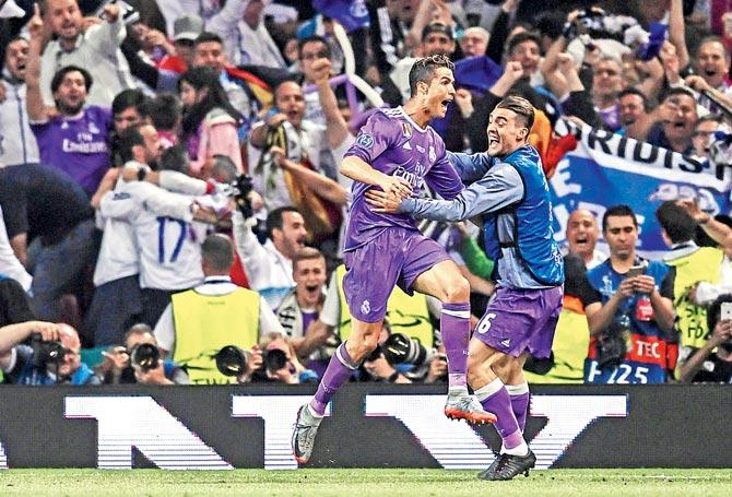 Real Madrid striker Cristiano Ronaldo (left) celebrates with his teammate after scoring the third goal against Juventus during the UEFA Champions League final in Cardiff in June this year. Pic/Getty Images
