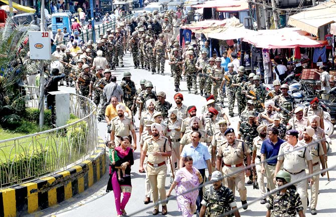Security forces march through Jalandhar, Punjab, on Saturday. The HC pulled up the government in Haryana and at the Centre for failure to stop ensure law and order after the rape conviction of godman Gurmeet Ram Rahim Singh. Pic/AFP