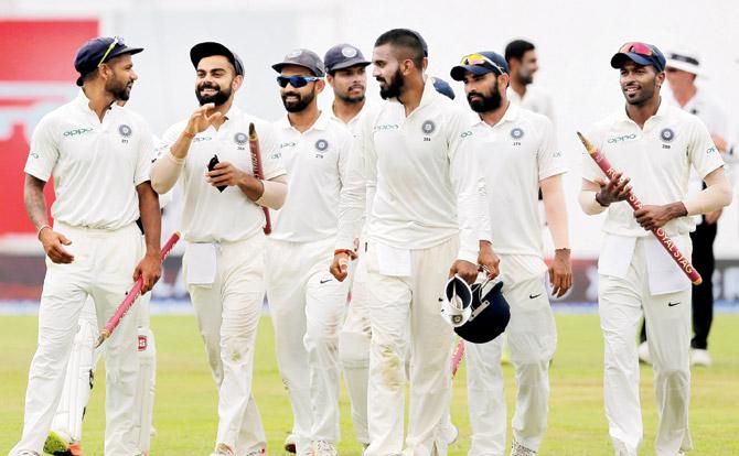 Team India skipper Virat Kohli (second from left) celebrates with teammates after winning the third Test against Sri Lanka in Kandy yesterday. Pic/AP,PTI