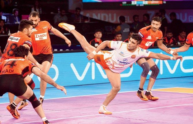 U Mumba (in orange) and a Puneri Paltan (white) player in action during their Pro Kabaddi League match at NSCI, Worli on Saturday