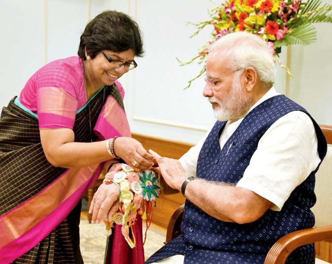 MSCW chairperson Vijaya Rahatkar ties the rakhi on PM Modi