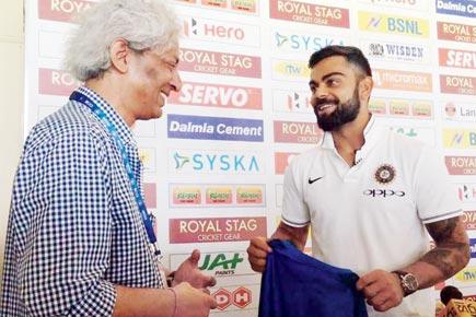 Virat Kohli gifts cricket writer a signed shirt for his century of Tests