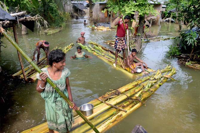People commute on banana rafts at a flood-hit village near Balurghat in South Dinajpur district of West Bengal. Pic/AFP