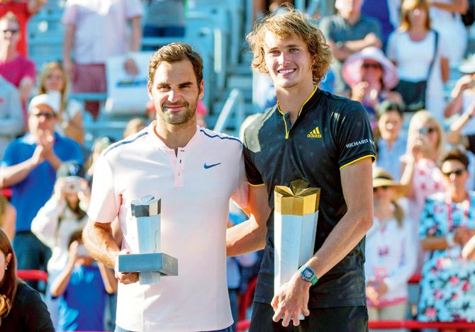 German Alexander Zverev (right) and Swiss Roger Federer pose with their trophies after the Rogers Cup final on Sunday. Pic/PTI