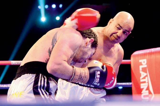India’s Akhil Kumar lands a punch on Australia’s Ty Gilchrist during the Battleground Asia bout on Saturday. Pic Suresh Karkera