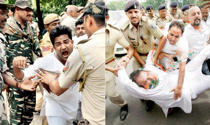 Police personnel detain Congress activists in Delhi and Ahmedabad on Saturday as nationwide protests erupted against the attack on Rahul Gandhi