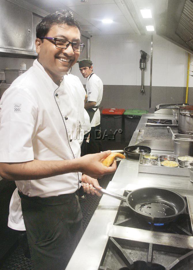 Chef Clyde Comello prepares crispy salmon with crispy kale at Theory, Kamala Mills. Pic/Tanvi Phondekar