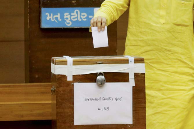 A member casts his vote for Rajya Sabha election at the Secretariat in Gandhinagar on Tuesday. Pic/ PTI