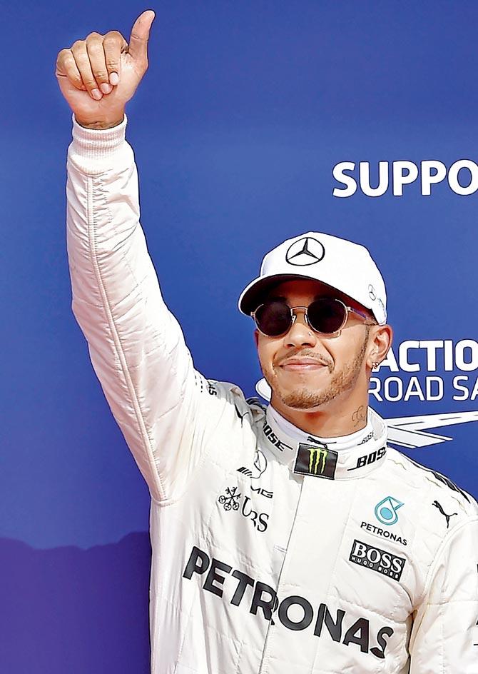 Lewis Hamilton celebrates after claiming pole position on Saturday. Pic/AFP