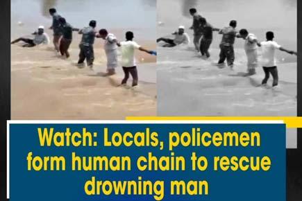 Watch: Locals, policemen form human chain to rescue drowning man