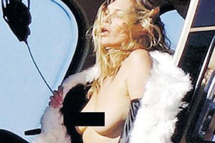 43-year-old supermodel Kate Moss poses topless in helicopter