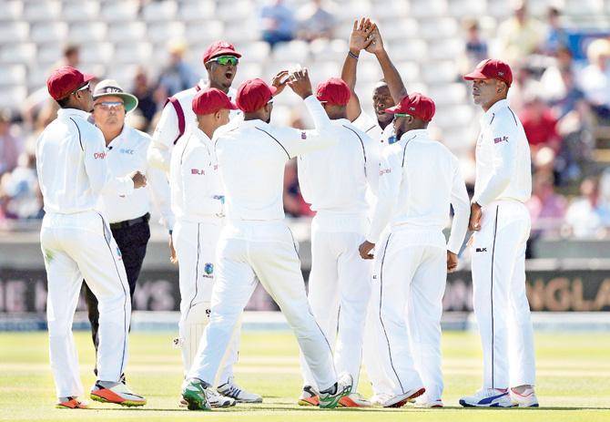 The West Indies team celebrate the wicket of England’s Mark Stoneman on Day One of the first Test at Edgbaston yesterday. Pic/PTI,AP