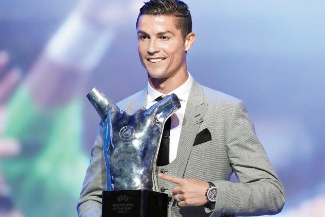 Cristiano Ronaldo poses with the UEFA Player of the Season trophy yesterday. pic/AFP