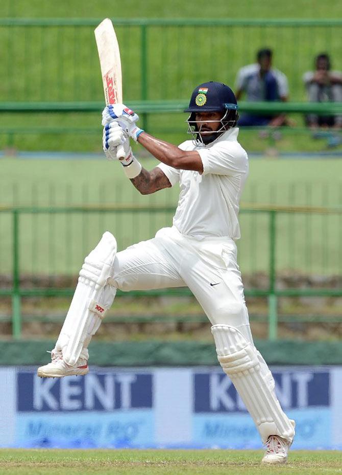 Indian cricketer Shikhar Dhawan plays a shot during the first day of the third and final Test match between Sri Lanka and India at the Pallekele International Cricket Stadium in Pallekele. / AFP PHOTO