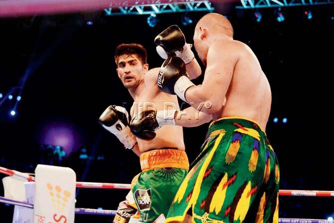 Indian boxer Vijender Singh battles Chinese boxer Zulpilkar Maimaitiali during the Battleground Asia bout on Saturday. Pic Suresh Karkera