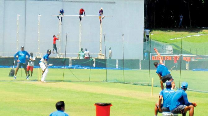Virat Kohli bowls to Shikhar Dhawan as Team India head coach Ravi Shastri looks on at the SSC ground yesterday. Pic/Jasvinder Sidhu