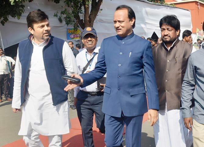 BJP MLA Ashish Deshmukh and NCP leader Ajit Pawar leave after attending the winter session of the state Assembly in Nagpur on Wednesday. Pic/PTI