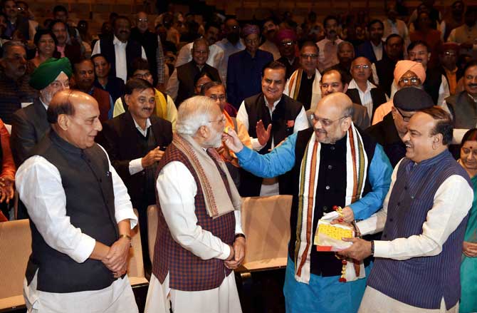 Prime Minister Narendra Modi being felicitated by BJP President Amit Shah and other party members after success in Gujarat and Himachal Pradesh Assembly election. Pic/ PTI