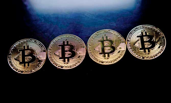 Gold plated souvenir Bitcoin coins. Bitcoin spiked to a dizzying record above USD 15,000 on frenzied speculative buying. Pics/AFP