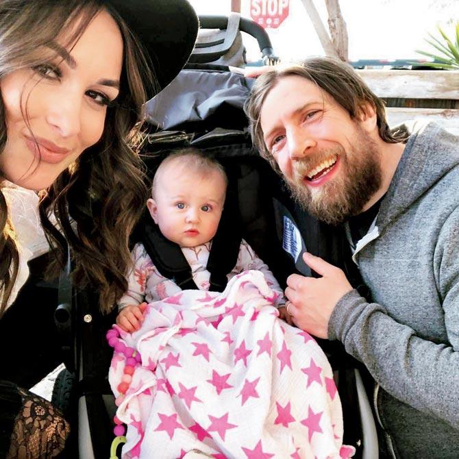 Brie Bella with daughter Birdie and husband Bryan
