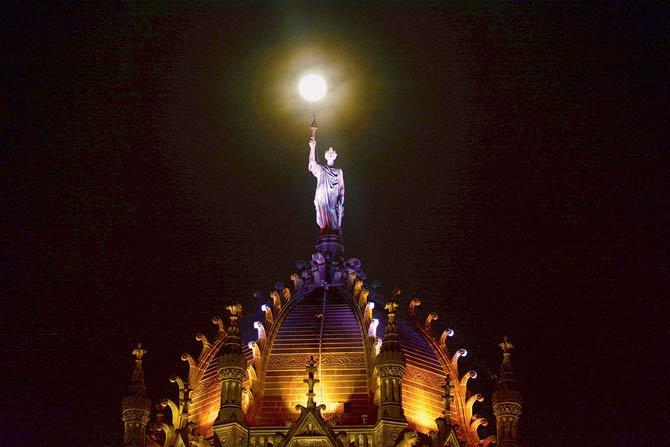 A full moon shines down on the gloriously-lit dome of the Chhatrapati Shivaji Maharaj Terminus. File pic